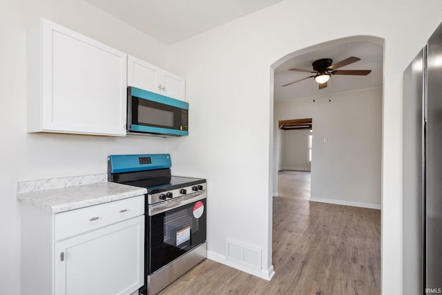 kitchen with white cabinetry, visible vents, a ceiling fan, light countertops, and stainless steel electric range