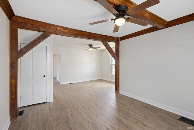 bonus room featuring visible vents, beamed ceiling, baseboards, and wood finished floors