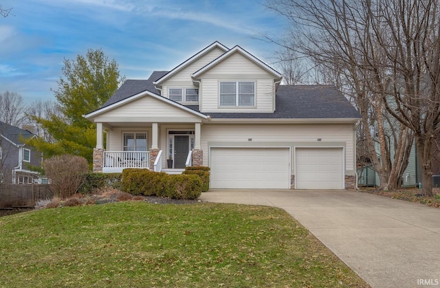 view of front of property with a shingled roof, covered porch, concrete driveway, a garage, and a front lawn