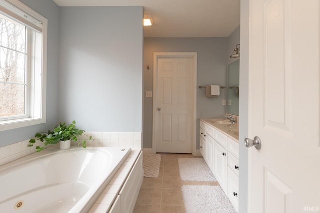 bathroom featuring vanity, a bath, and tile patterned floors