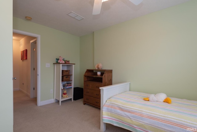 bedroom featuring baseboards, a ceiling fan, visible vents, and light colored carpet