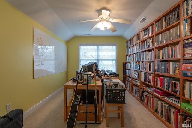 home office featuring lofted ceiling, ceiling fan, carpet flooring, and visible vents