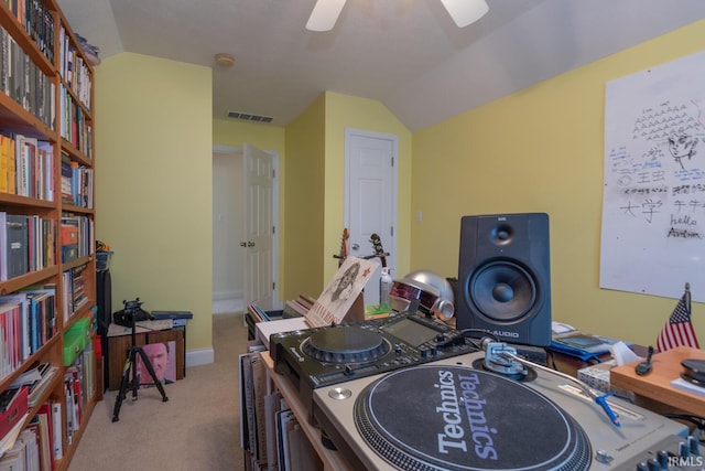 interior space featuring baseboards, visible vents, a ceiling fan, vaulted ceiling, and carpet flooring