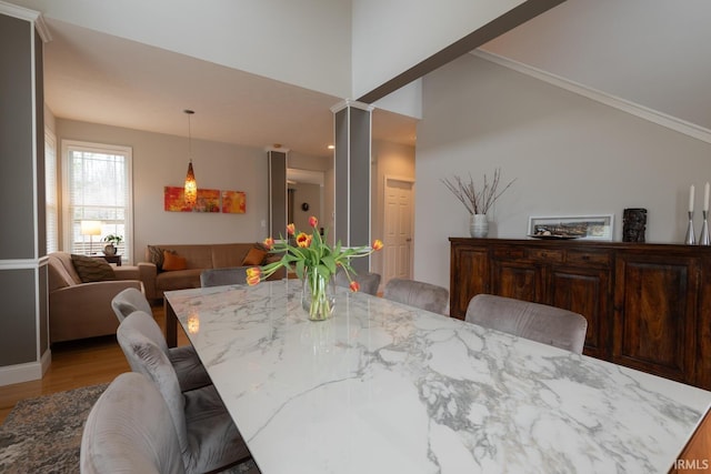 dining room featuring lofted ceiling and light wood-style floors