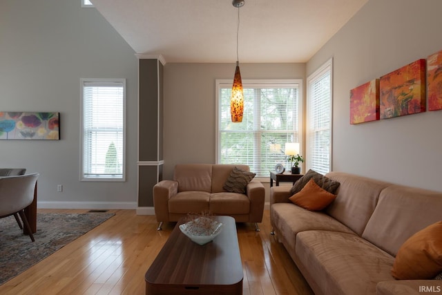 living room featuring light wood-type flooring and baseboards