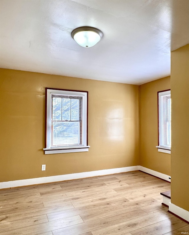 empty room with wood finished floors and baseboards