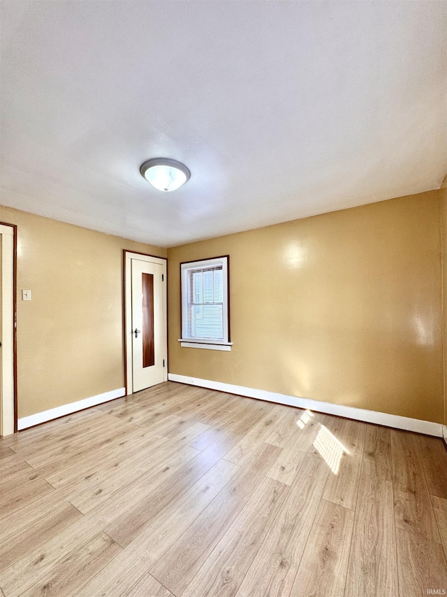 empty room with wood finished floors and baseboards