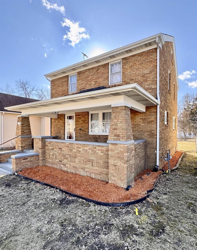 back of property featuring brick siding