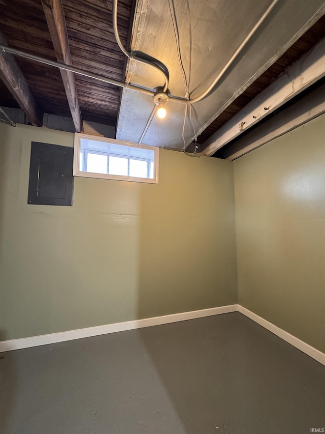 basement with electric panel and baseboards