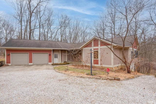 single story home with driveway and an attached garage