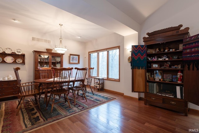 dining space with visible vents, baseboards, and wood finished floors