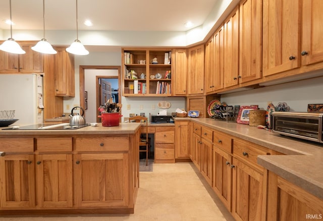 kitchen with a toaster, decorative light fixtures, open shelves, light countertops, and freestanding refrigerator