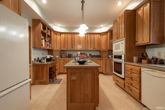 kitchen with recessed lighting, white appliances, a kitchen island, brown cabinetry, and pendant lighting