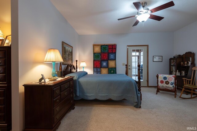 bedroom featuring light carpet and a ceiling fan