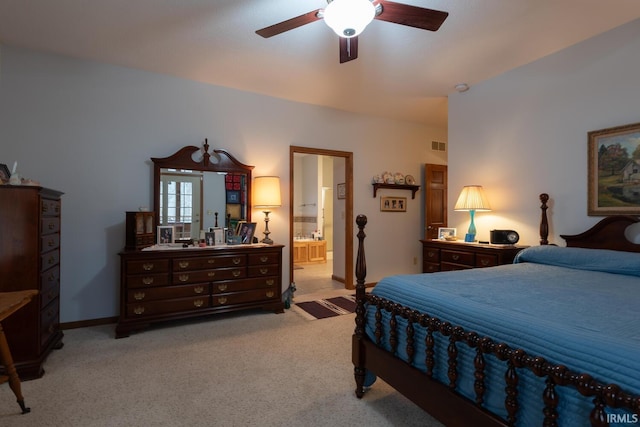 bedroom featuring light carpet, ceiling fan, ensuite bath, and visible vents