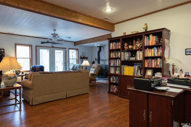 living area featuring visible vents, dark wood finished floors, a ceiling fan, beamed ceiling, and crown molding