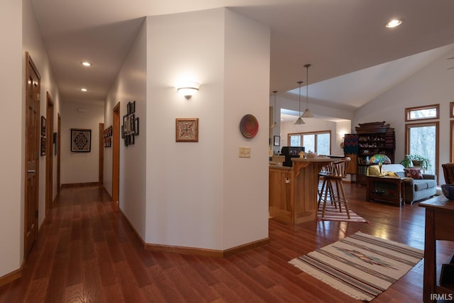 hallway with dark wood-type flooring, recessed lighting, and plenty of natural light