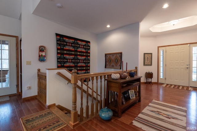 foyer entrance featuring baseboards, wood finished floors, and recessed lighting