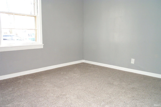 spare room with carpet floors and baseboards