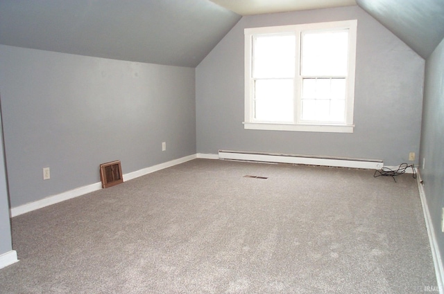 additional living space with baseboards, visible vents, vaulted ceiling, and baseboard heating