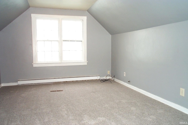 additional living space featuring carpet floors, a baseboard radiator, vaulted ceiling, and baseboards