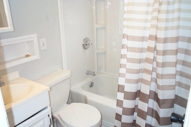 bathroom with shower / bath combo, vanity, and toilet