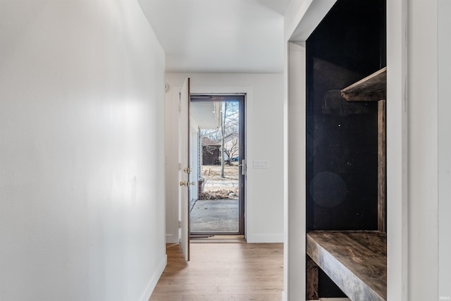 interior space featuring baseboards and wood finished floors