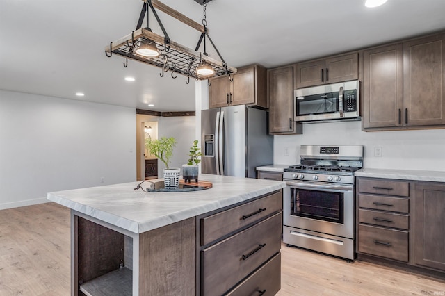 kitchen featuring appliances with stainless steel finishes, light wood-type flooring, light countertops, and recessed lighting