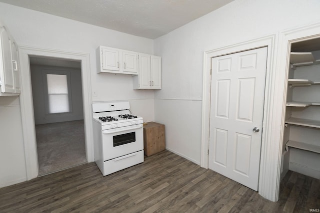 kitchen featuring dark wood-style floors, light countertops, gas range gas stove, and white cabinets