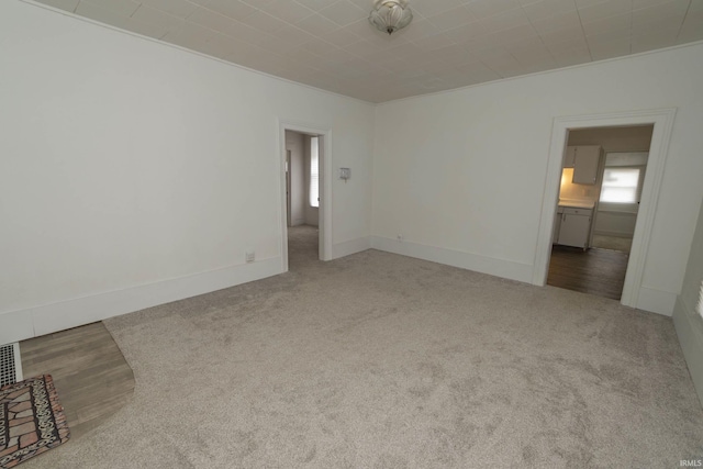 spare room with carpet floors and baseboards