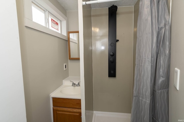 full bath featuring vanity and a shower with shower curtain