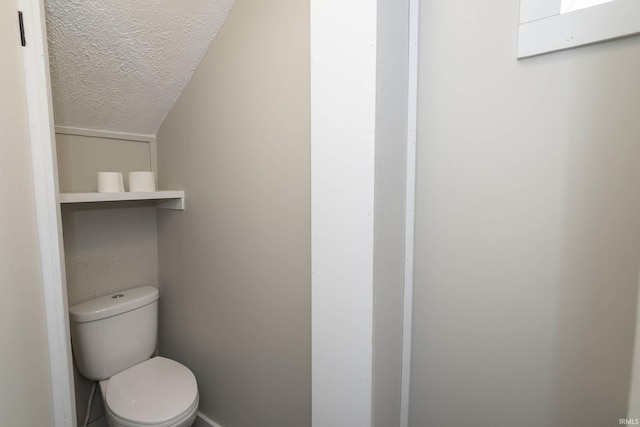 bathroom featuring a textured ceiling and toilet