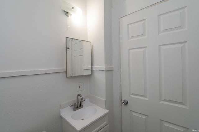 bathroom with tile walls and vanity