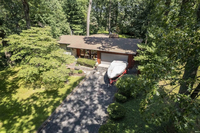 birds eye view of property with a view of trees