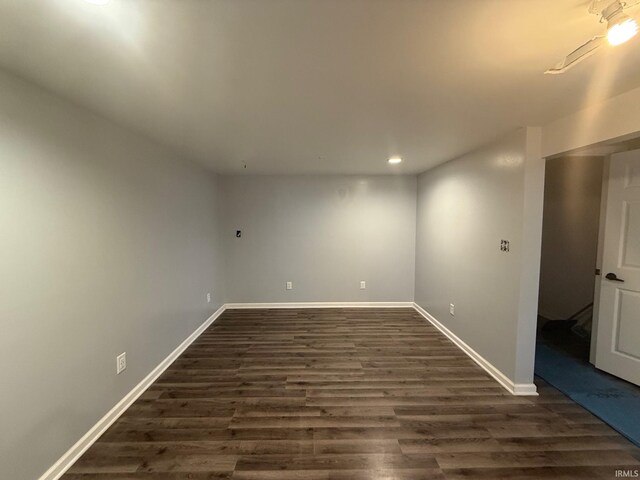 unfurnished room with dark wood-style floors and baseboards