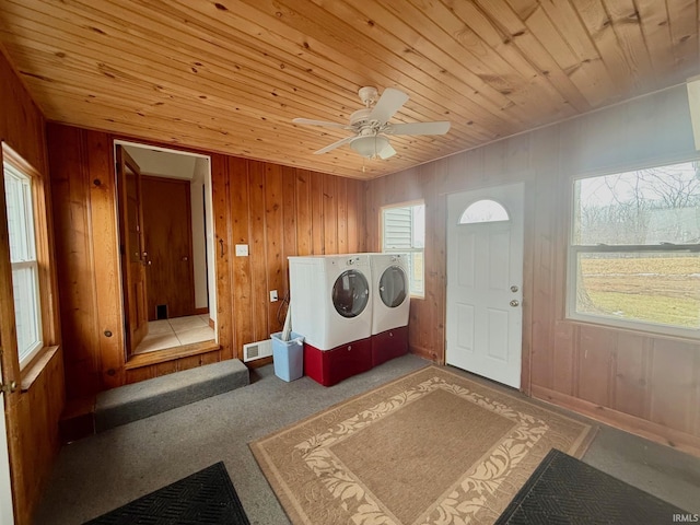 laundry room featuring laundry area, wood walls, independent washer and dryer, and wood ceiling