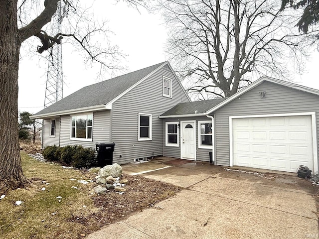 view of front of property with driveway, an attached garage, and a shingled roof