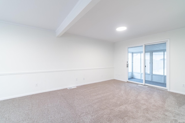 carpeted empty room featuring visible vents, baseboards, beamed ceiling, and ornamental molding