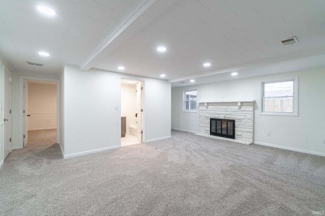 unfurnished living room with baseboards, visible vents, carpet flooring, a fireplace, and recessed lighting