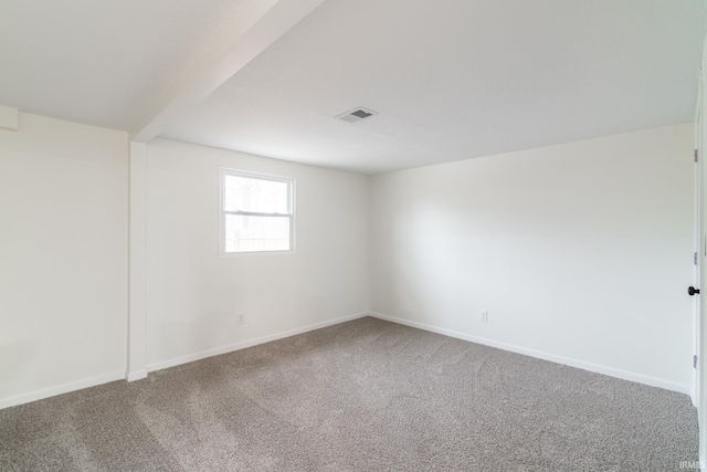 unfurnished room featuring baseboards, visible vents, and carpet flooring