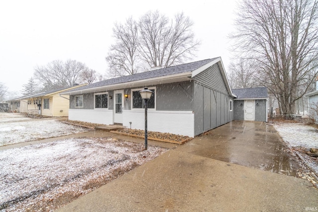 single story home featuring roof with shingles