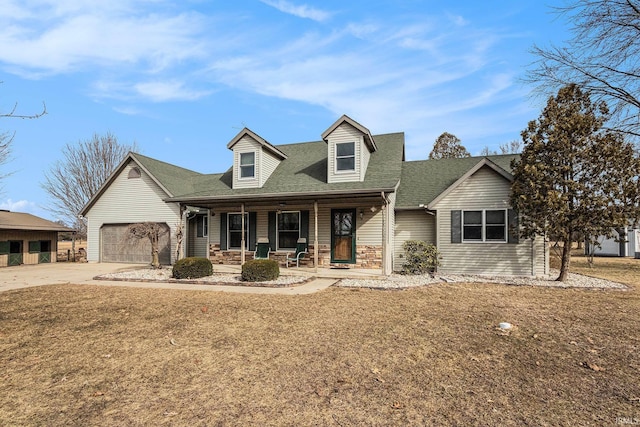 cape cod house with a porch, concrete driveway, and a shingled roof