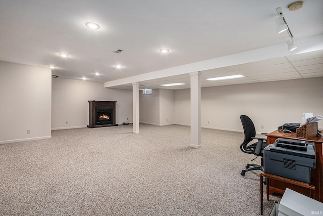 carpeted office space featuring a warm lit fireplace, recessed lighting, rail lighting, and baseboards