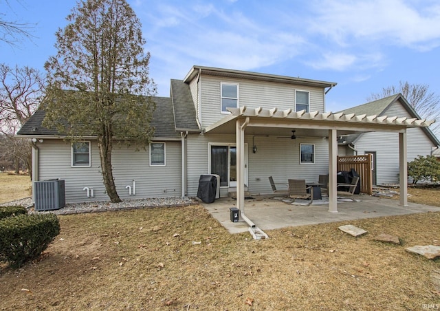 back of property with ceiling fan, central AC unit, a shingled roof, a pergola, and a patio area