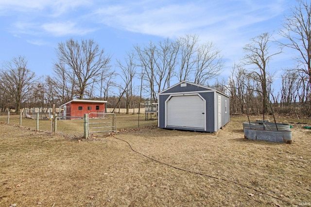 view of yard with a shed, an outdoor structure, and fence