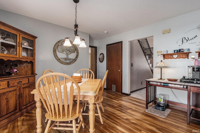 dining space with stairs and wood finished floors