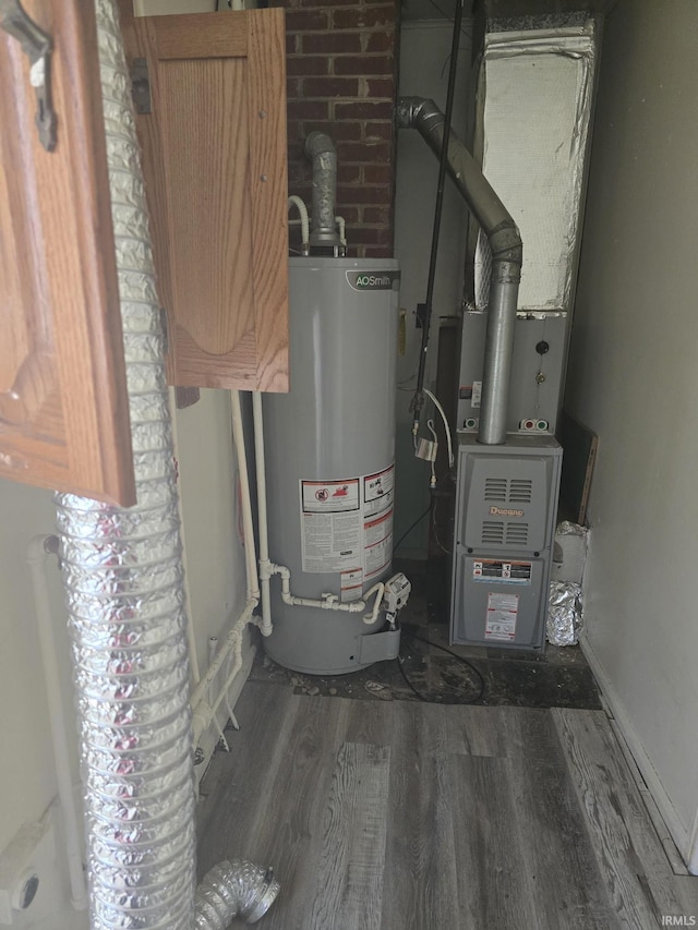 utility room featuring heating unit and gas water heater