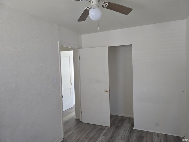 unfurnished bedroom featuring a ceiling fan, wood finished floors, and a closet