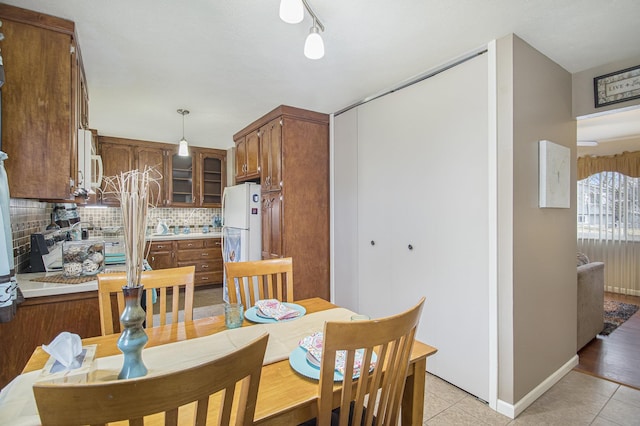 dining room with light tile patterned floors and baseboards