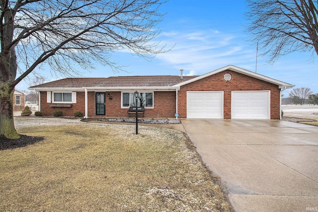 ranch-style home featuring concrete driveway, brick siding, an attached garage, and a front yard